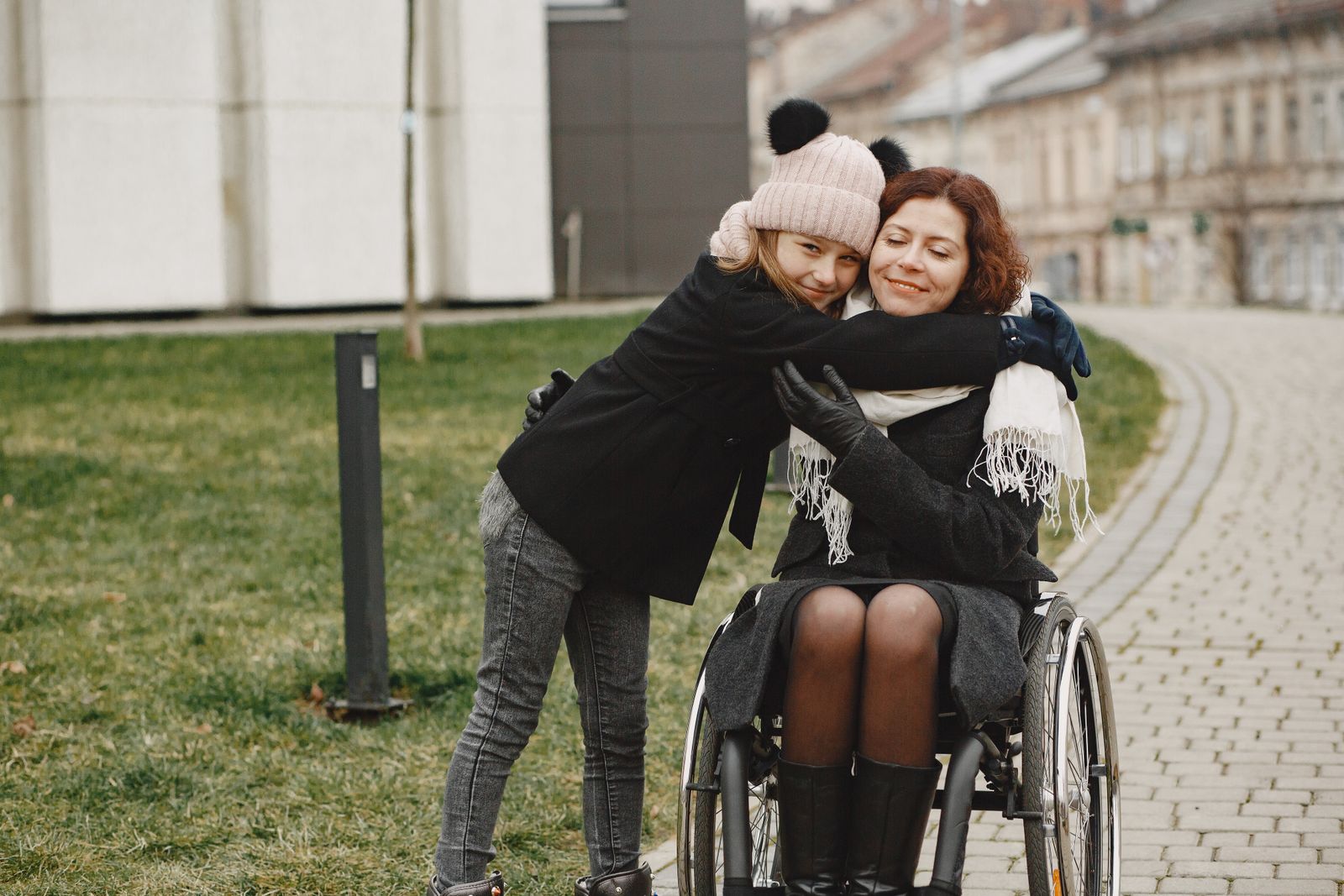 NDIS participant sharing a warm hug with a family member outdoors